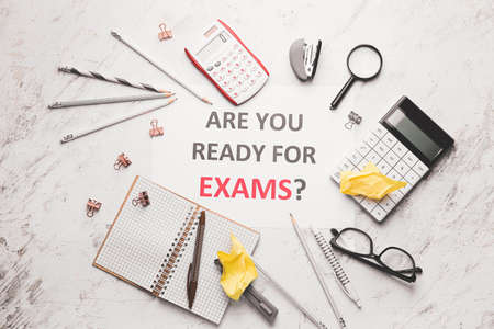 Stationery and paper sheet with text ARE YOU READY FOR EXAMS? on white backgroundの写真素材