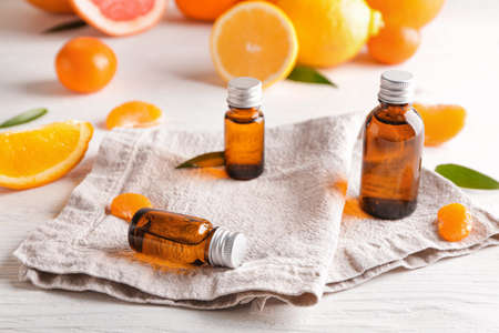 Bottles of citrus essential oils on table