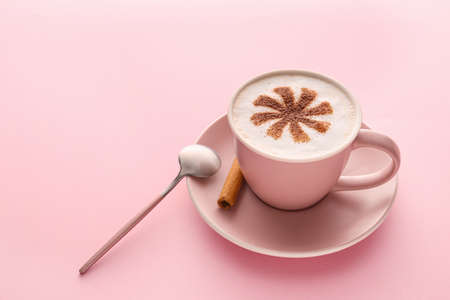 Cup of tasty cappuccino on color backgroundの写真素材