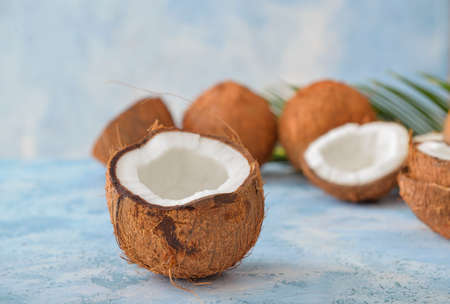 Tasty coconuts on color background