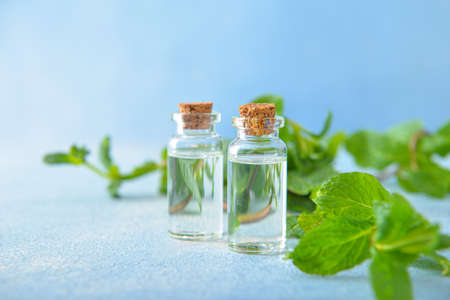 Bottles of mint essential oil on tableの写真素材