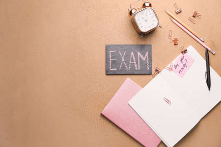 Stationery and alarm clock on color background. Concept of preparation for examの写真素材