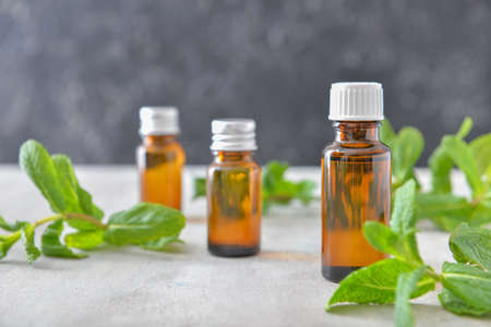 Bottles of mint essential oil on tableの写真素材