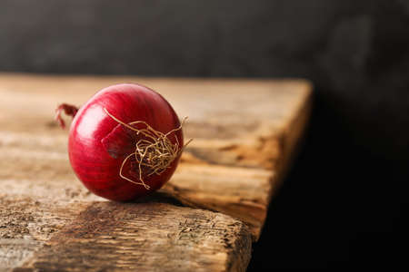 Fresh raw onion on wooden tableの写真素材