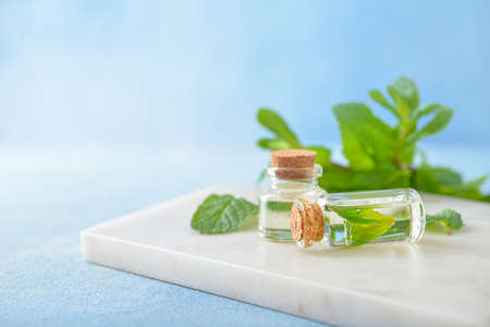 Bottles of mint essential oil on tableの写真素材