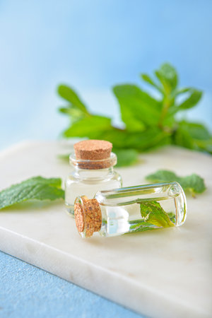 Bottles of mint essential oil on tableの写真素材