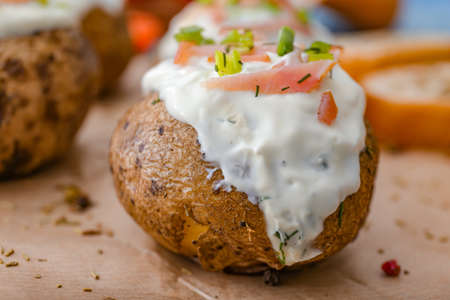 Tasty baked potato with sour cream on table, closeupの写真素材