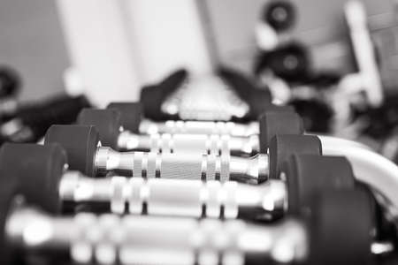 Dumbbells on stand in modern gymの写真素材