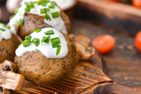 Tasty baked potato with sour cream on table, closeupの写真素材