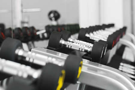 Dumbbells on stand in modern gymの写真素材
