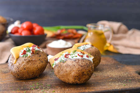 Tasty baked potato with sour cream on tableの写真素材