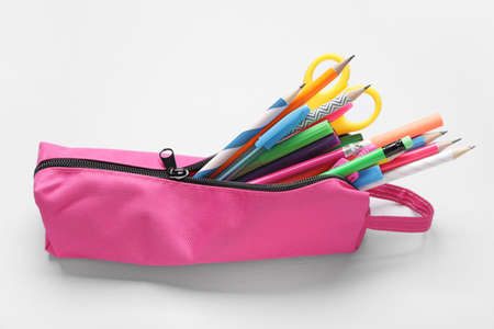 Pencil bag with stationery on white background