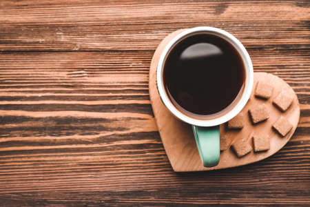 Cup of coffee with sugar on wooden backgroundの写真素材