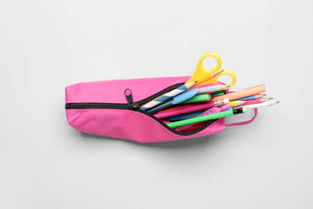 Pencil bag with stationery on white background