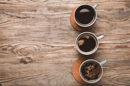 Cups of coffee on wooden backgroundの写真素材
