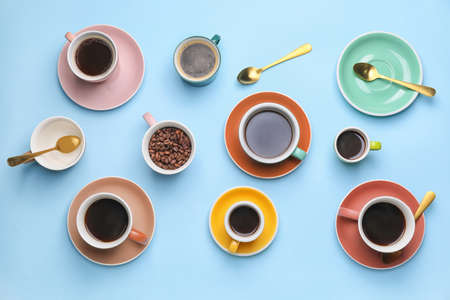 Cups of coffee on color backgroundの写真素材