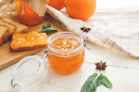 Jar of orange jam on white tableの写真素材