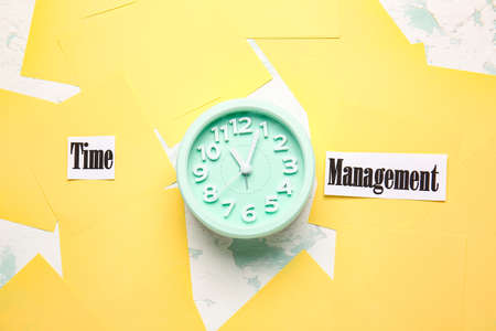 Alarm clock and text TIME MANAGEMENT on tableの写真素材
