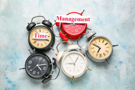 Alarm clocks on table. Time management conceptの写真素材