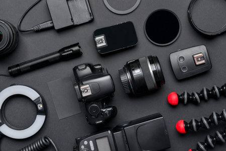 Modern photographer's equipment and card on dark backgroundの写真素材