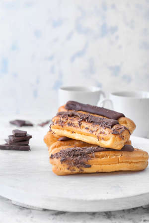 Tasty eclairs on white boardの写真素材