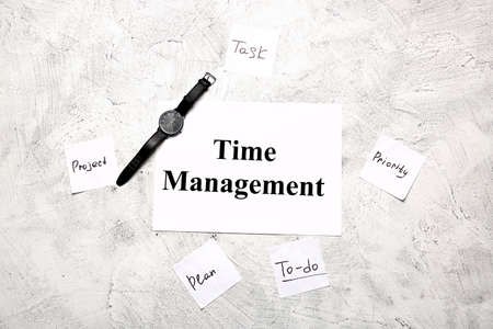 Watch, papers and sheet with text TIME MANAGEMENT on light background