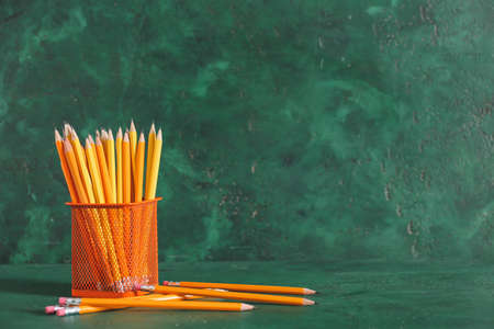 Holder with pencils on color backgroundの写真素材