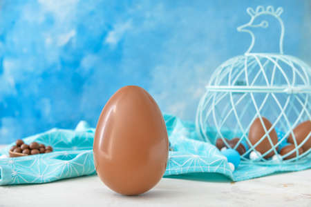 Tasty chocolate Easter egg on tableの写真素材