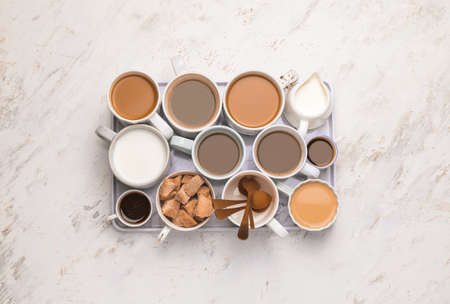 Composition with cups of different coffee on light backgroundの写真素材