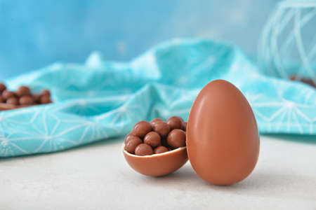 Tasty chocolate Easter eggs with candies on tableの写真素材