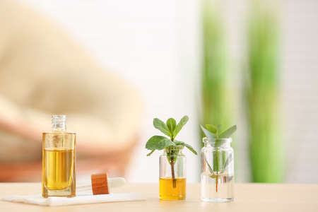 Bottles with different essential oils on tableの写真素材