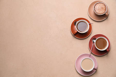 Cups of different coffee on color backgroundの写真素材