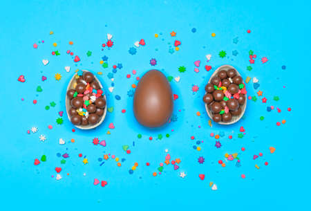 Tasty chocolate Easter eggs on color backgroundの写真素材