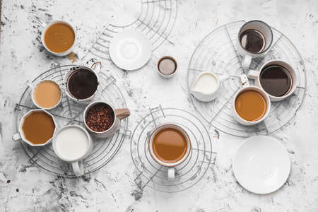 Composition with cups of different coffee on light backgroundの写真素材
