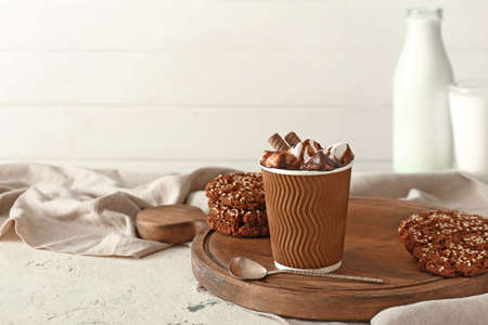 Cup of hot chocolate with cookies on table