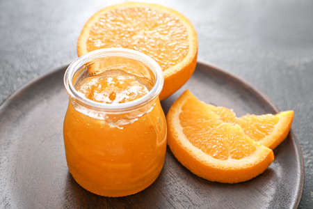 Jar of orange jam on dark backgroundの写真素材