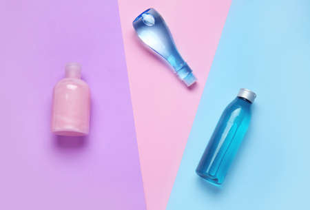 Bottles of shampoo on color backgroundの写真素材