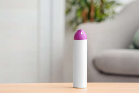 Bottle of air freshener on table in roomの写真素材