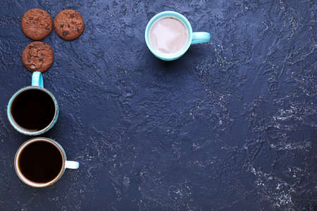 Cups of coffee with cookies on dark backgroundの写真素材