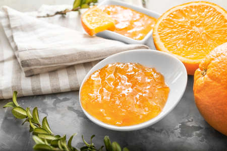 Plate with orange jam on gray backgroundの写真素材