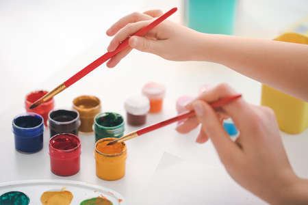 Drawing teacher giving private art lessons to little girl at home, closeupの写真素材