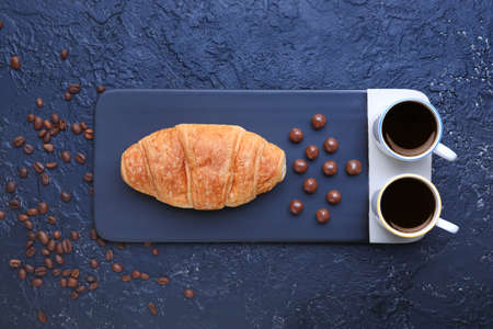 Cups of coffee with sweets on dark backgroundの写真素材