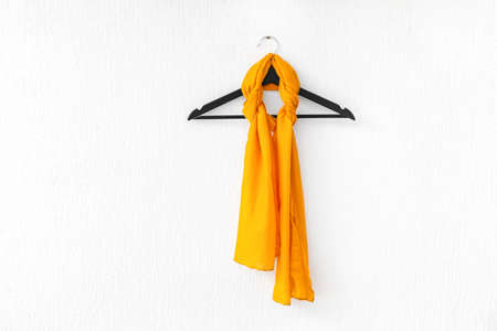 Hanger with beautiful scarf on white backgroundの写真素材