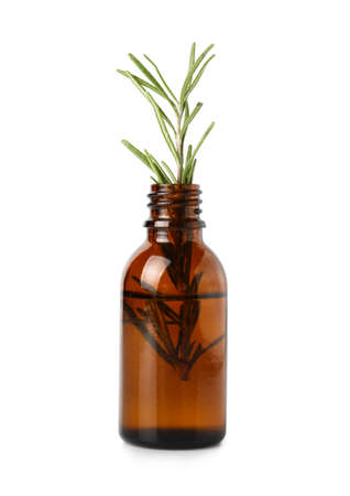 Bottle with rosemary essential oil on white backgroundの写真素材