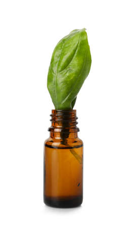 Bottle with basil essential oil on white backgroundの写真素材