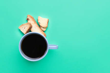 Cup of coffee with cookies on color backgroundの写真素材