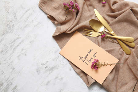 Table setting with card for Mother's day dinner on white backgroundの写真素材