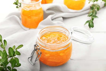 Jar of orange jam on tableの写真素材