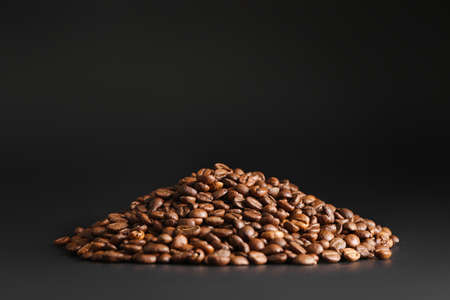 Heap of coffee beans on dark backgroundの写真素材