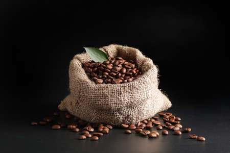 Bag with coffee beans on dark backgroundの写真素材